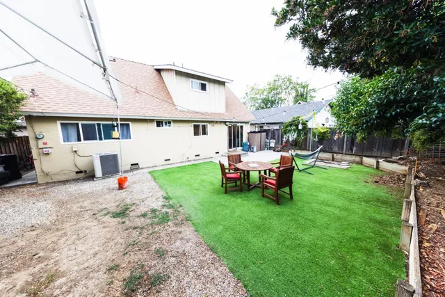 a view of a backyard with chairs and a patio