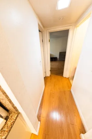 a view of a room with wooden floor