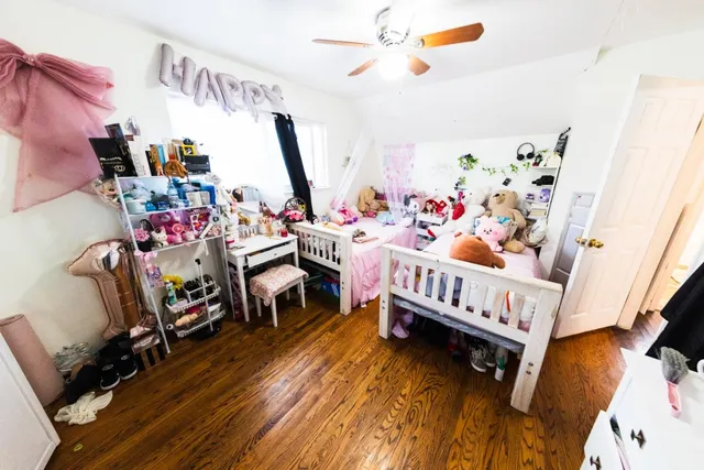 a bedroom with furniture and a wooden floor