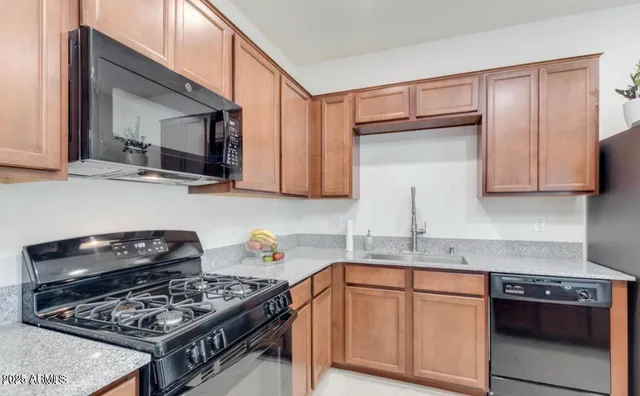 a kitchen with stainless steel appliances granite countertop a stove and a microwave