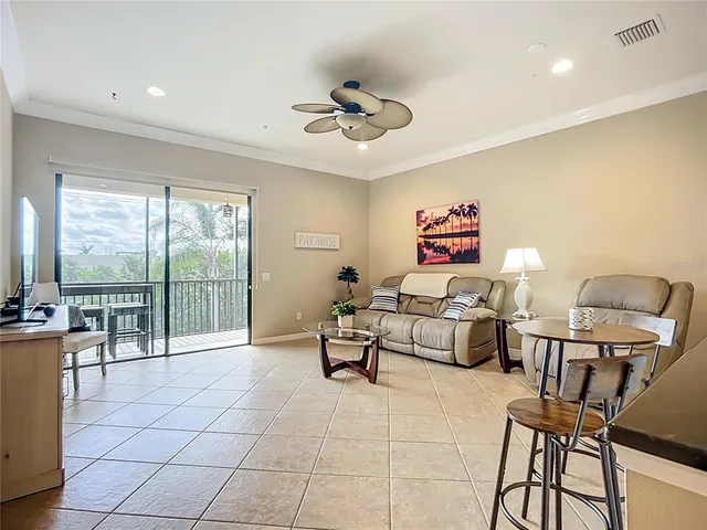 a living room with furniture and a floor to ceiling window