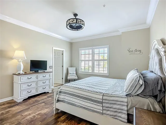 a bedroom with a bed and a television