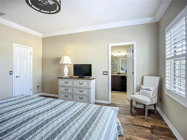 a bedroom with a bed and a television