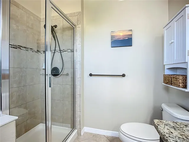 a bathroom with a toilet and a shower