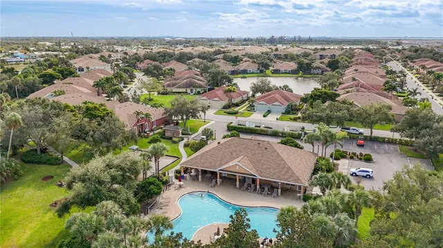 an aerial view of residential house with outdoor space and trees all around