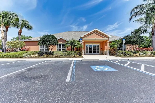 a front view of a house with a yard and potted plants