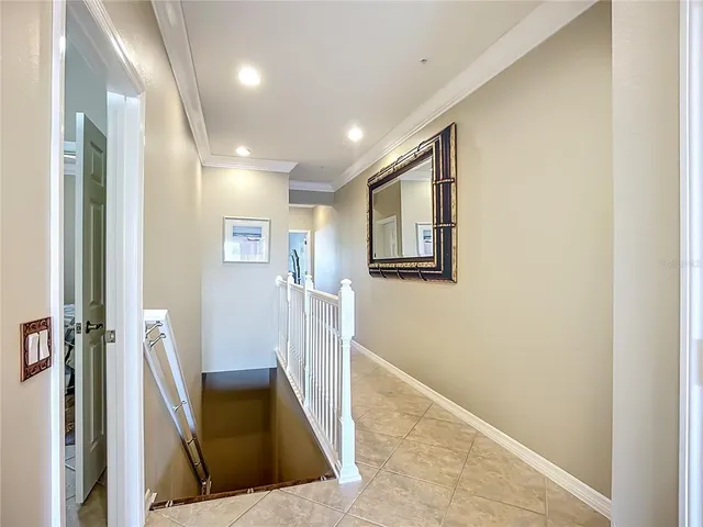 a view of a hallway with windows and stairs