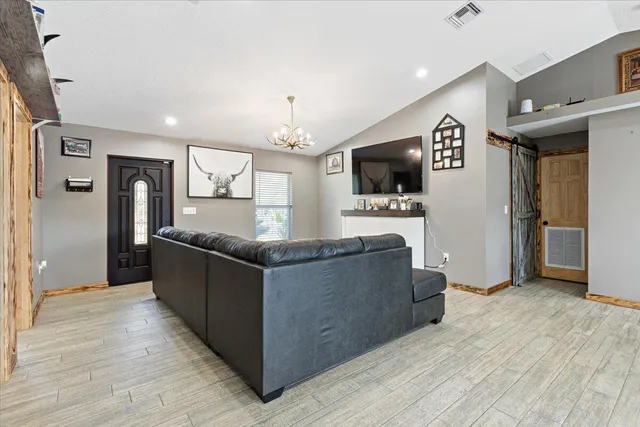 a living room with hard wood floors and a window