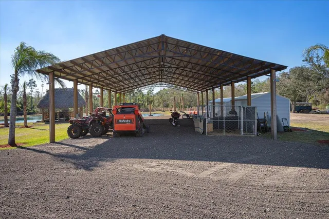 a kitchen with stainless steel appliances kitchen island granite countertop a sink a stove a dining table and chairs