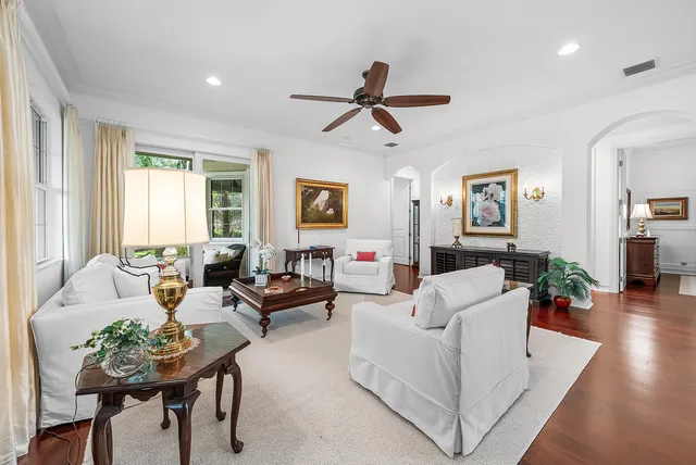 a view of a dining room and livingroom with furniture wooden floor a chandelier