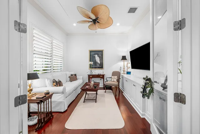 a kitchen with stainless steel appliances granite countertop a stove top oven a refrigerator a dining table and chairs with wooden floor