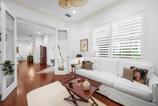 a kitchen with a stove a refrigerator a sink dishwasher with a dining table and chairs with wooden floor