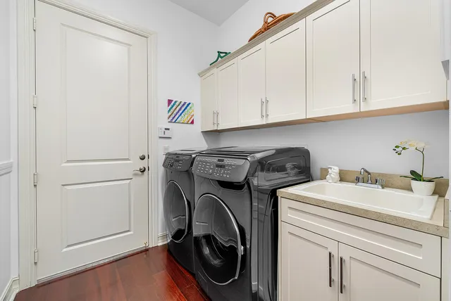 a spacious bathroom with a double vanity sink mirror and bathtub