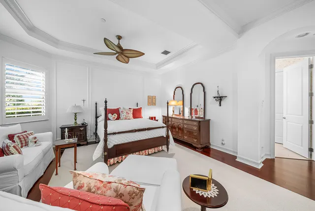 a bedroom with a bed and a flat tv screen on dresser