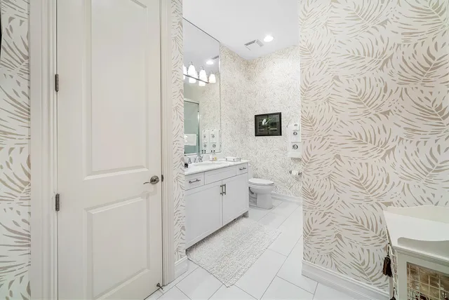 a outdoor dining room with furniture a rug and a chandelier