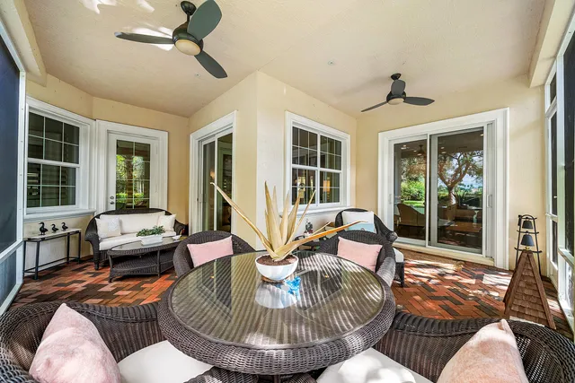 a view of a house with backyard porch and sitting area
