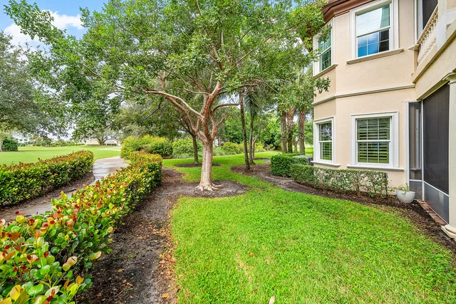 an aerial view of residential houses with outdoor space and swimming pool