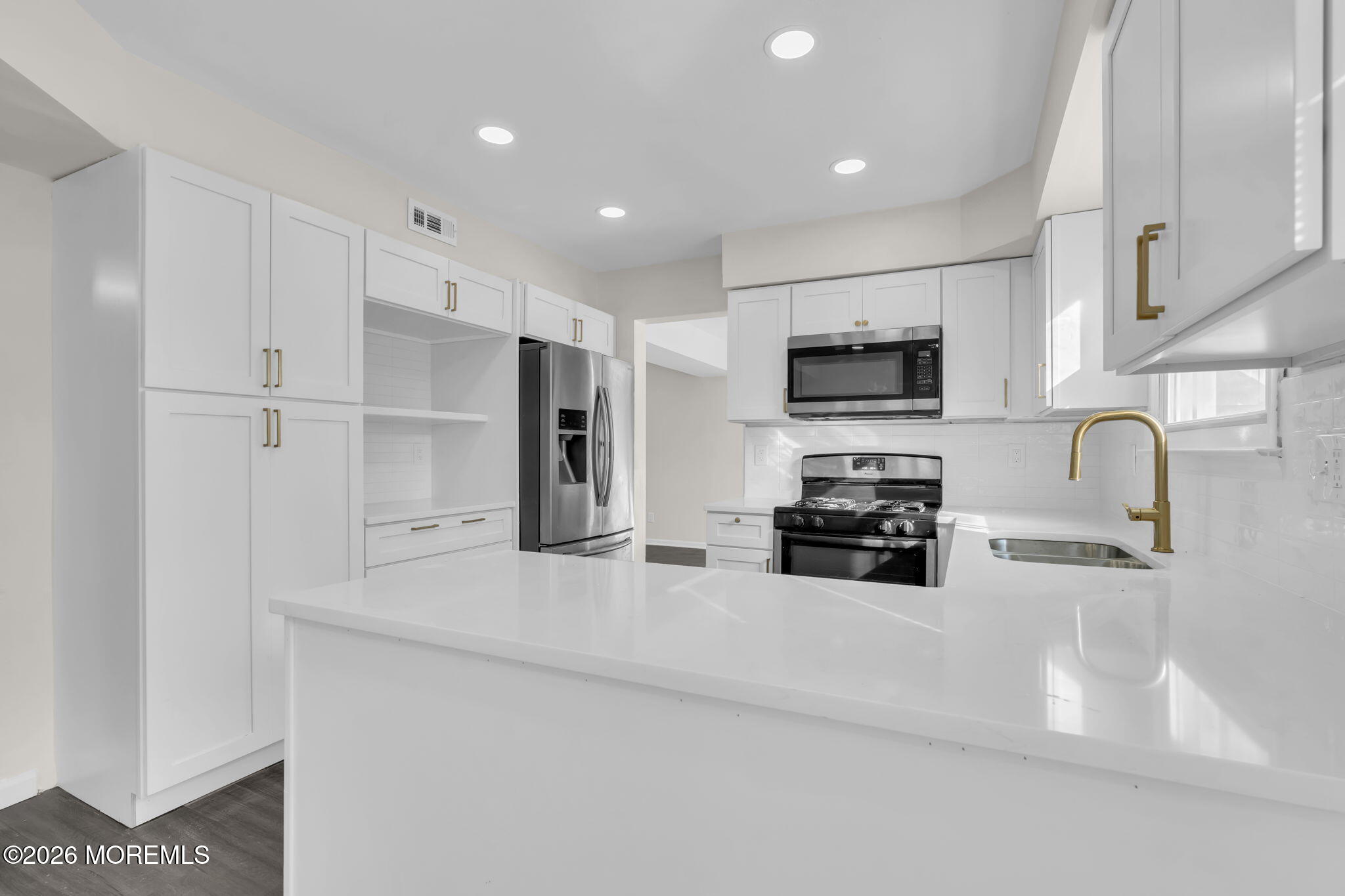 45 Peachstone Road Howell, NJ 07731 - Photo 22 of 54 a kitchen with granite countertop a refrigerator and a stove top oven