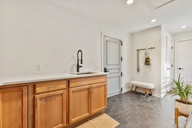 a living room with furniture and a potted plant