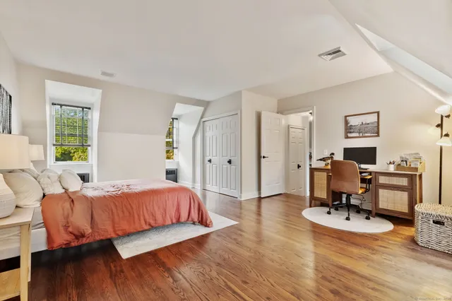a bedroom with furniture and a wooden floor