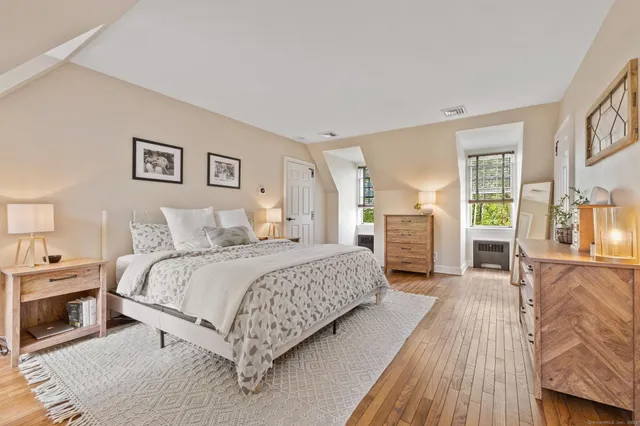 a spacious bedroom with a bed and a couch