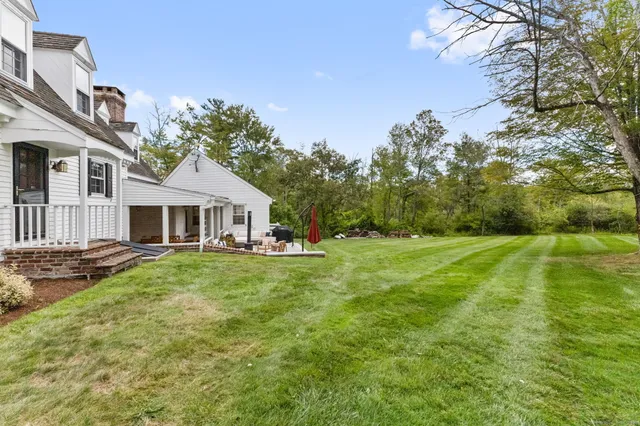 a front view of a house with yard and green space