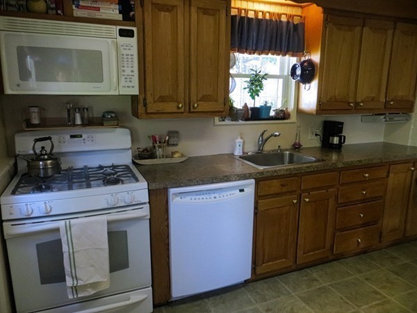 969 Allen Street Springfield, MA 01118 - Photo 8 of 21 a kitchen with stainless steel appliances granite countertop a sink stove and microwave