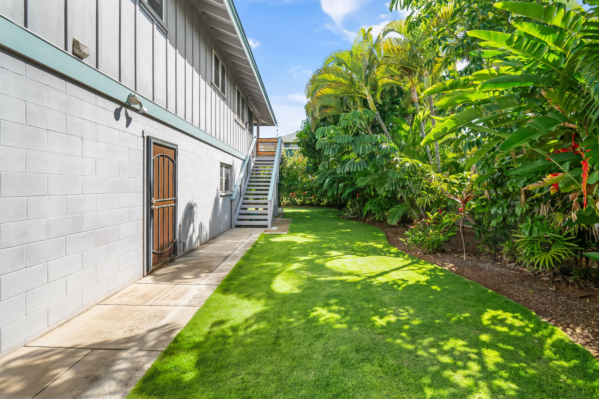 8244 A Elepaio Road Kekaha, HI 96752 - Photo 21 of 21 a backyard of a house with lots of green space