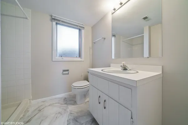 a bathroom with a sink toilet and mirror