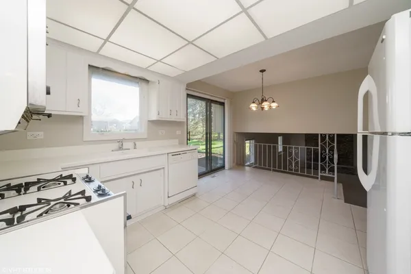 a kitchen with stainless steel appliances a sink stove and cabinets