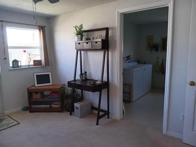 a view of workspace with window and couch