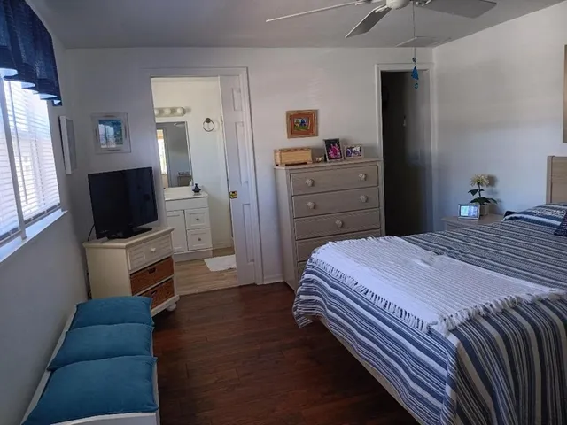 a bedroom with a bed and a flat screen television