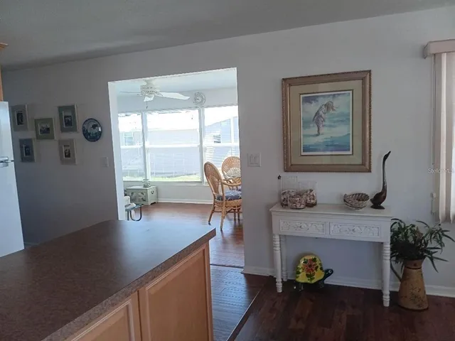 a living room with dining table and wooden floor