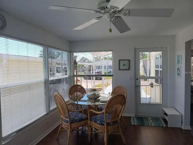 a dining room with furniture a chandelier and wooden floor