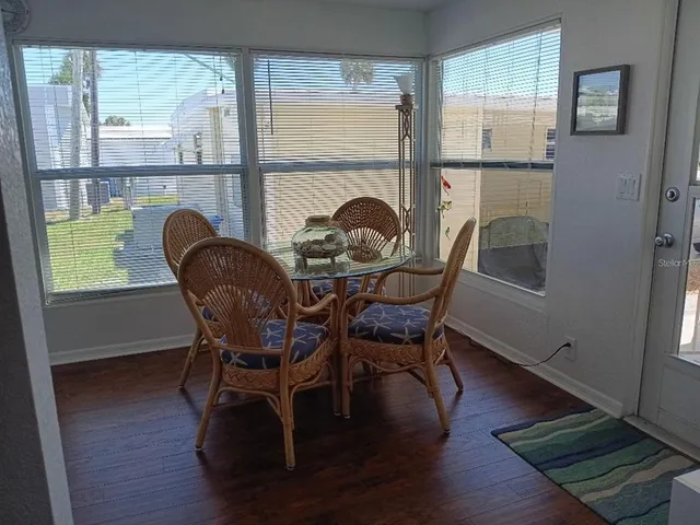 a dining room with furniture and window