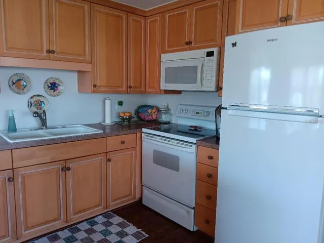 a kitchen with stainless steel appliances granite countertop a refrigerator sink and cabinets