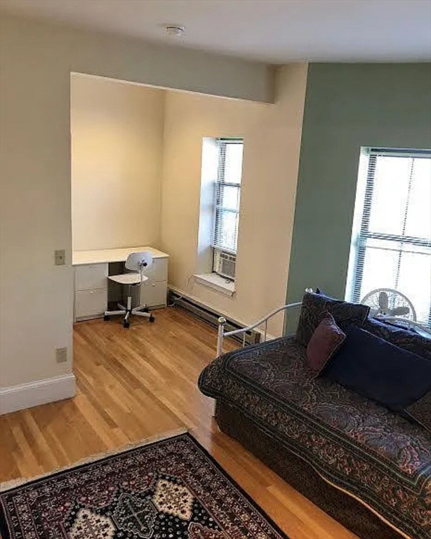 533 Columbus Avenue, Unit 8 Boston, MA 02118 - Photo 5 of 21 a bedroom with a bed and wooden floor