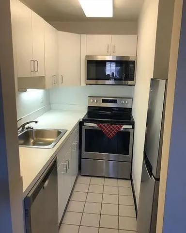 a kitchen with a sink stove and cabinets