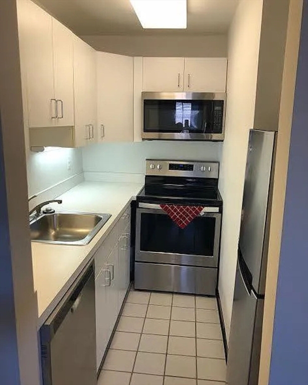 533 Columbus Avenue, Unit 8 Boston, MA 02118 - Photo 8 of 21 a kitchen with a sink stove and cabinets