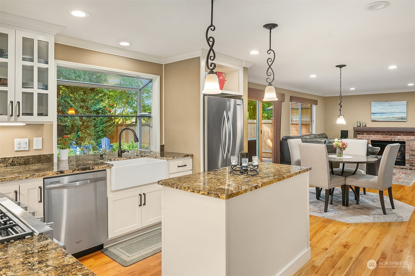 4927 Northeast 23rd Street Renton, WA 98059 - Photo 10 of 40 a kitchen with stainless steel appliances granite countertop a stove top oven a dining table and chairs