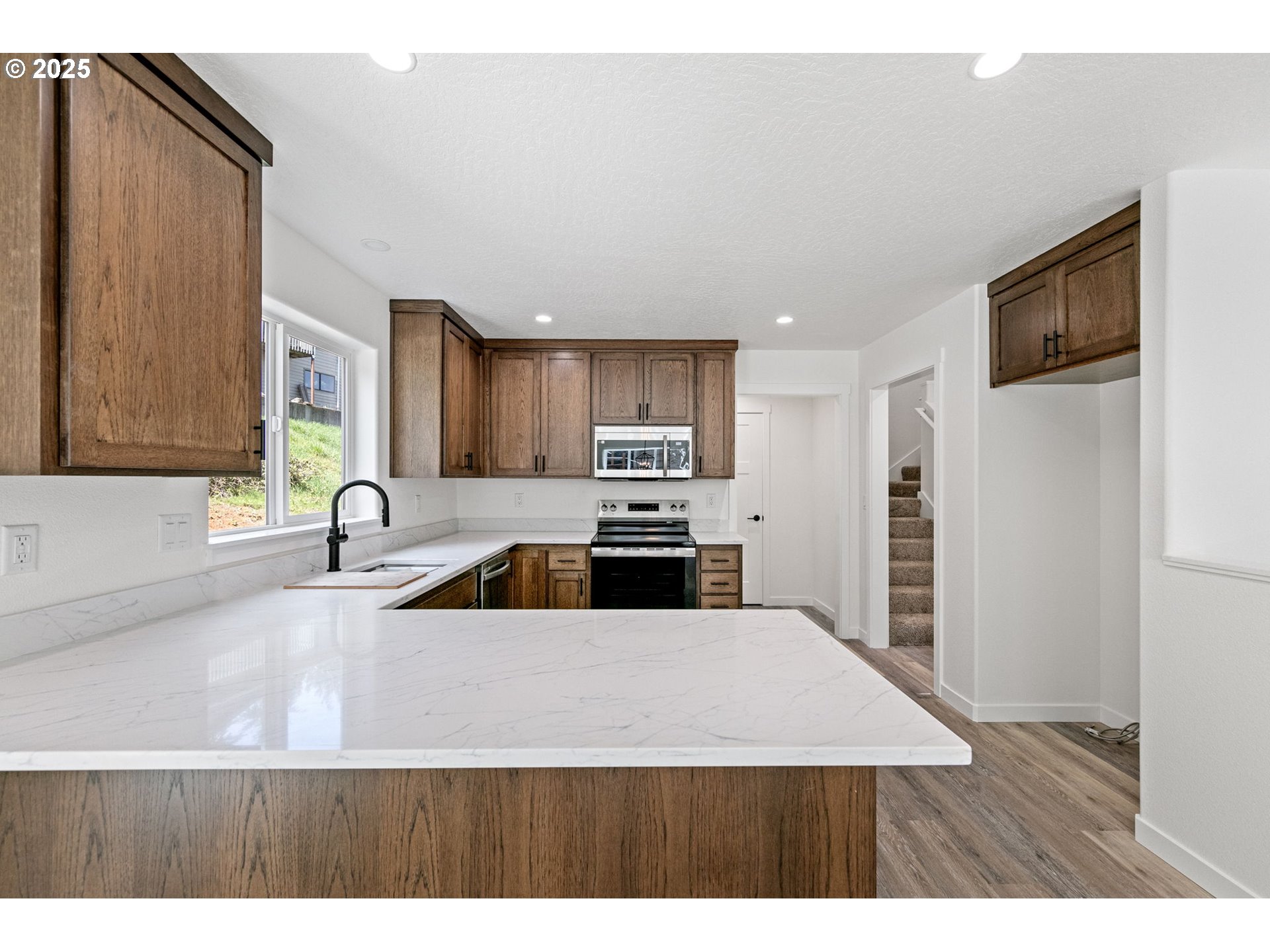 65 Bangle Court Cottage Grove, OR 97424 - Photo 11 of 44 a kitchen with stainless steel appliances granite countertop a sink refrigerator and cabinets