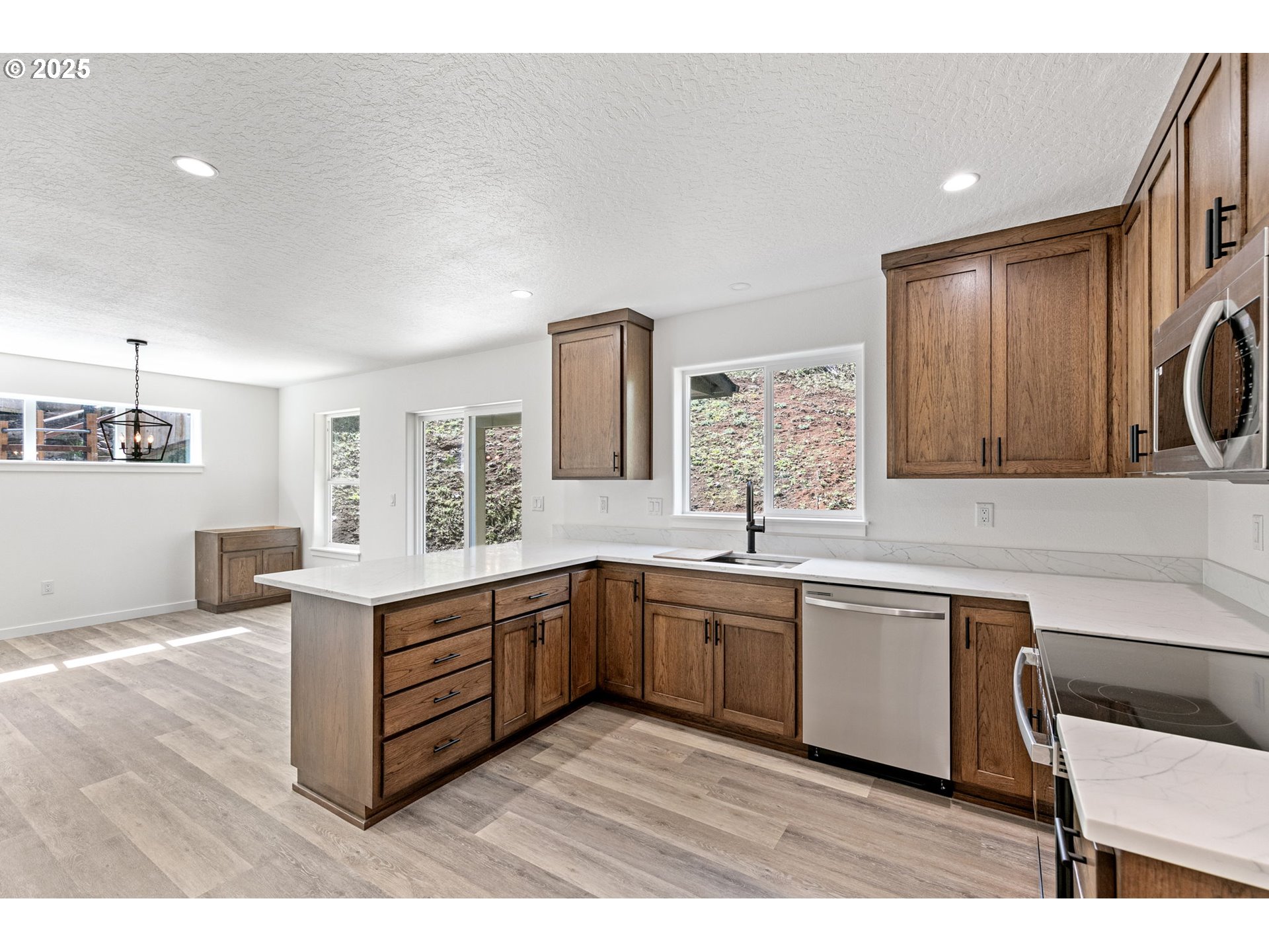 65 Bangle Court Cottage Grove, OR 97424 - Photo 14 of 44 a large kitchen with stainless steel appliances granite countertop a sink and cabinets