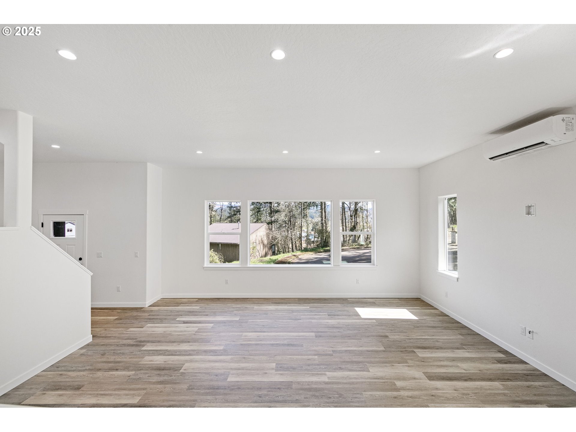 65 Bangle Court Cottage Grove, OR 97424 - Photo 4 of 44 a view of an empty room with wooden floor and a window