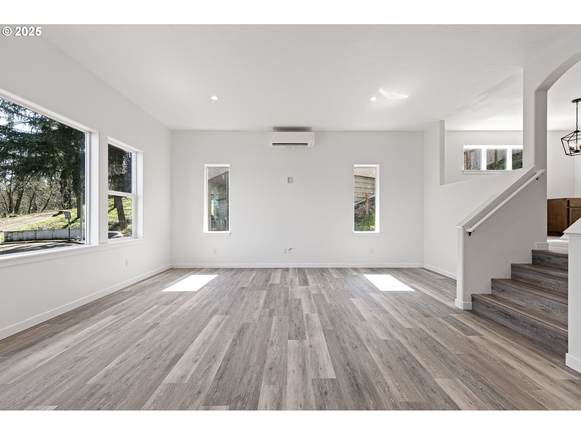 65 Bangle Court Cottage Grove, OR 97424 - Photo 5 of 44 a view of an empty room with wooden floor and a window