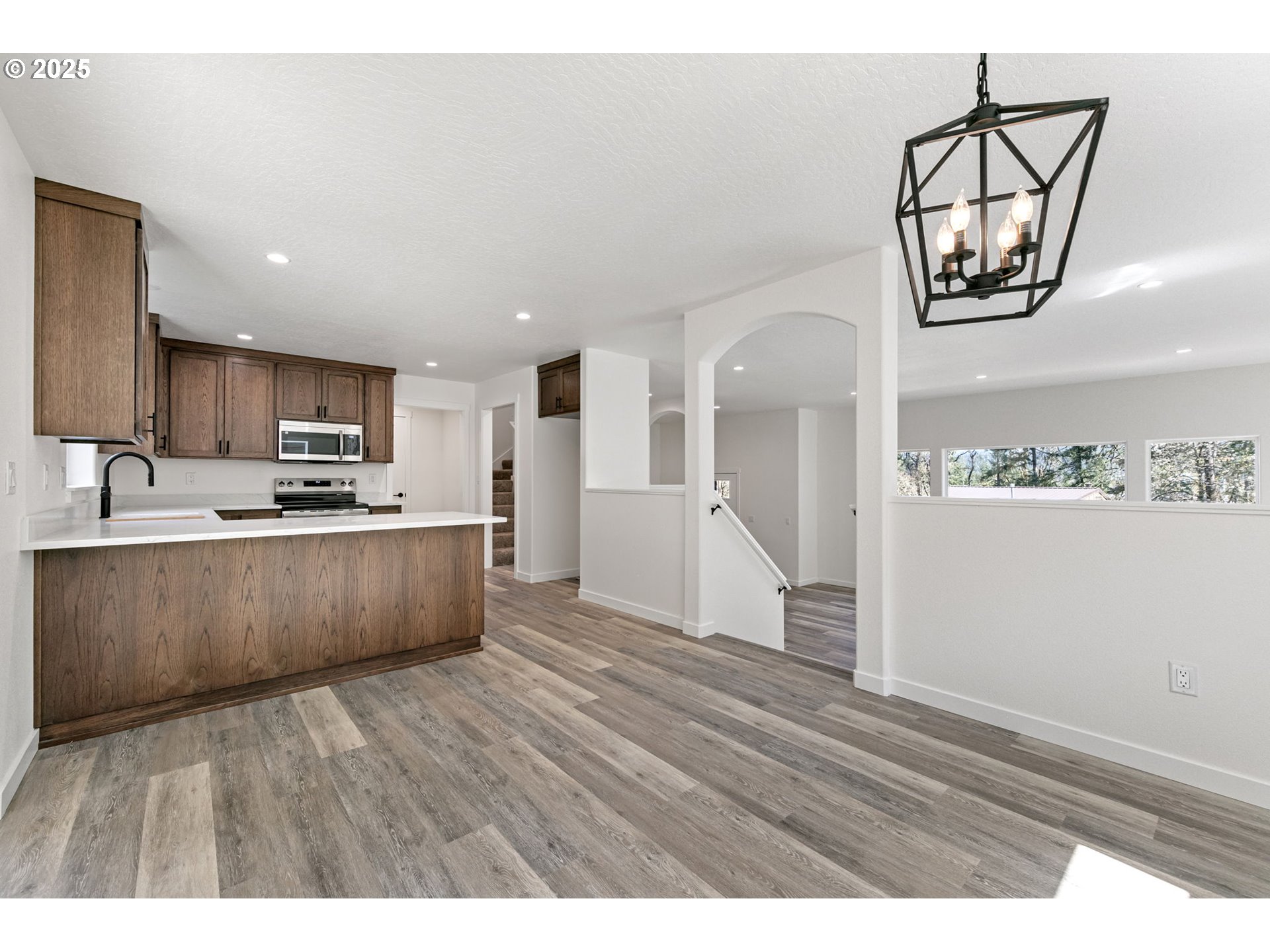 65 Bangle Court Cottage Grove, OR 97424 - Photo 10 of 44 a view of kitchen with stainless steel appliances granite countertop a stove top oven a sink with wooden floors
