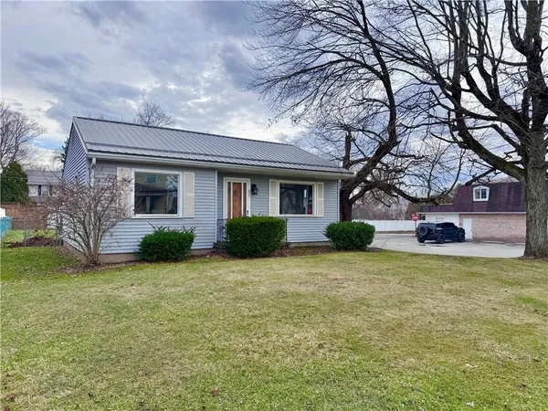 a view of a house with a yard and garage