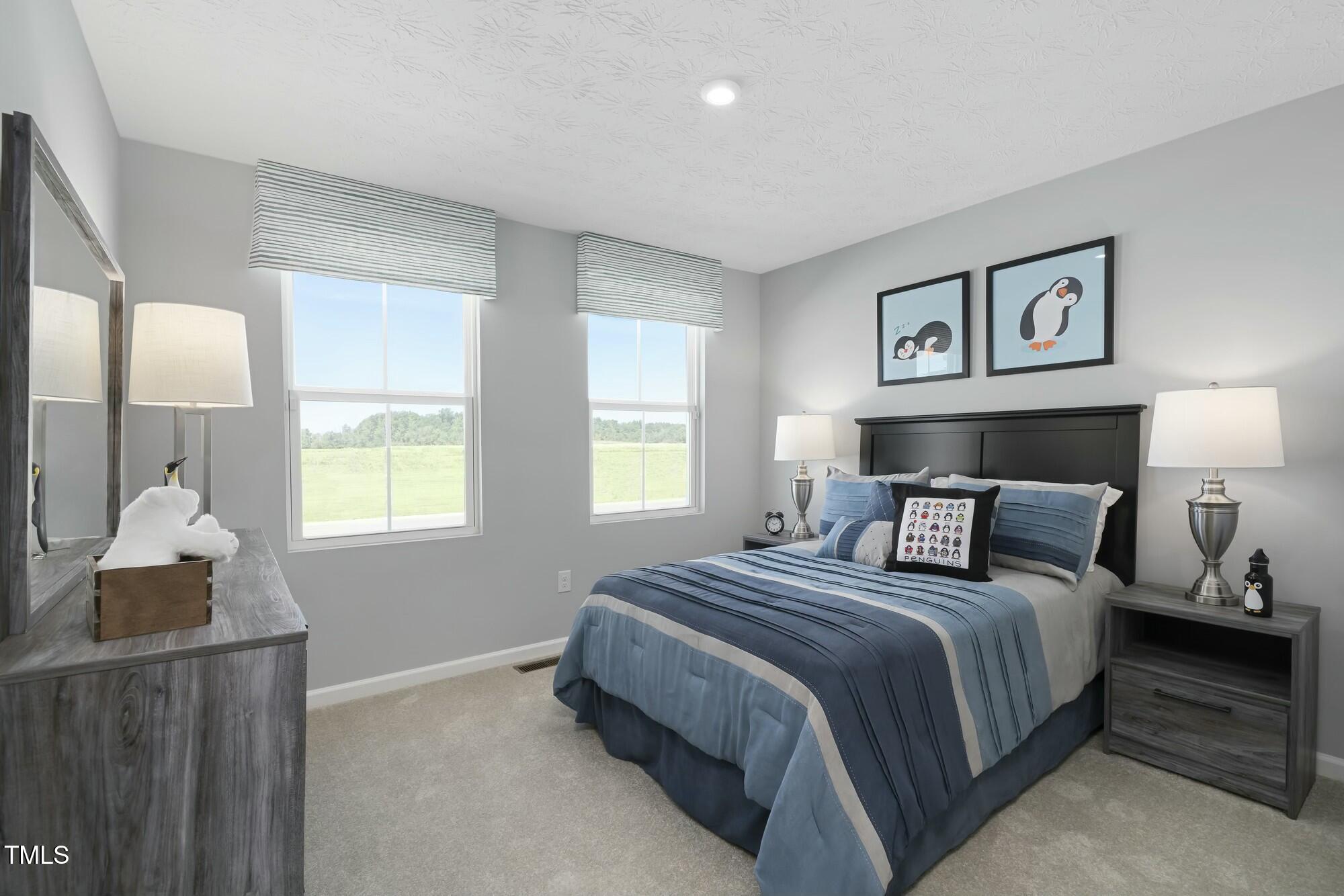3941 Dragonfly Road Bailey, NC 27807 - Photo 11 of 12 a bedroom with a bed and window