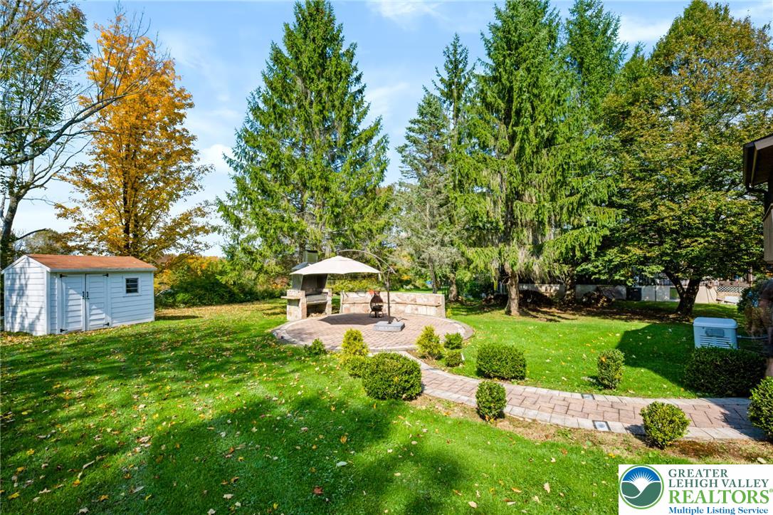 1605 Ridgeview Drive Lake Ariel, PA 18436 - Photo 35 of 40 Towering mature trees frame a peaceful grassy yard complete with a stone patio walkway.