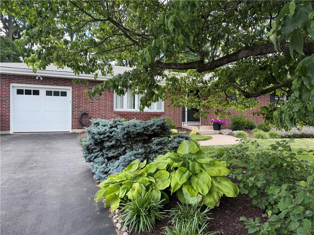 5334 Egypt Road Laurys Station, PA 18059 - Photo 3 of 55 Mature trees and vibrant landscaping frame this inviting brick facade with an integrated garage.