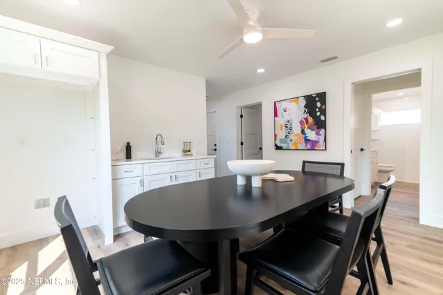 a view of a livingroom with wooden floor and furniture